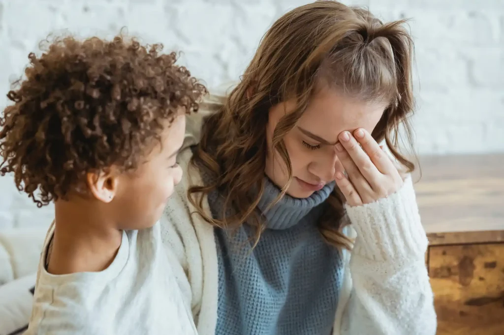 What is motherhood really like? Woman being comforted by son
