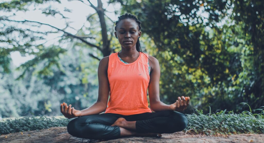woman meditating in the outdoors. Books for World Meditation Day