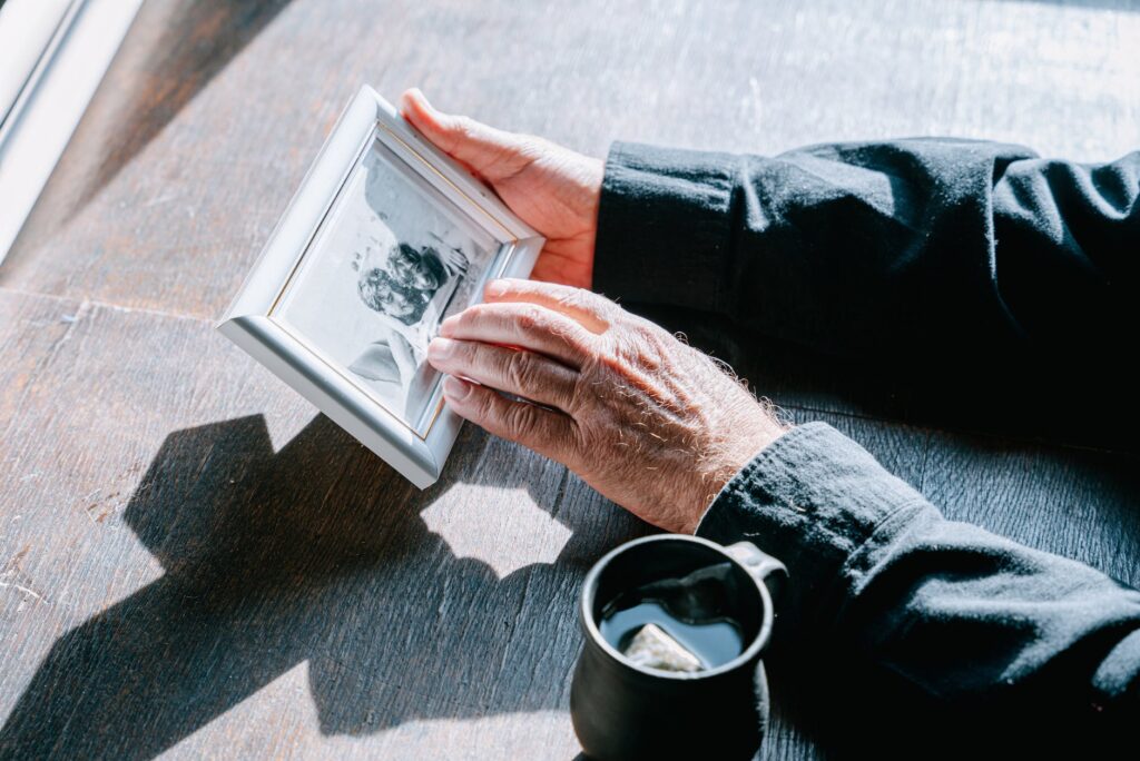 a person in black long sleeves holding a picture frame