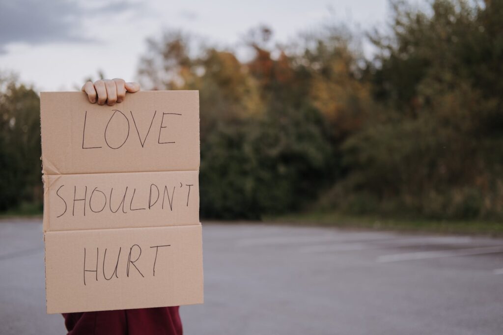 person with carton with inscription love should not hurt