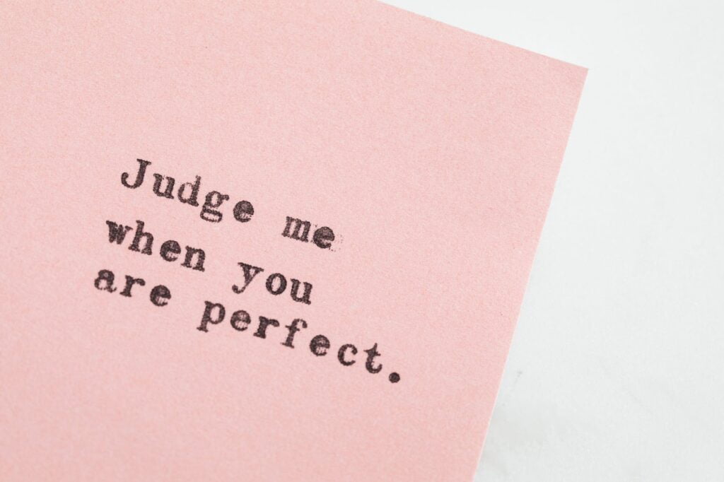 typed message on pink paper. What is perfectionism