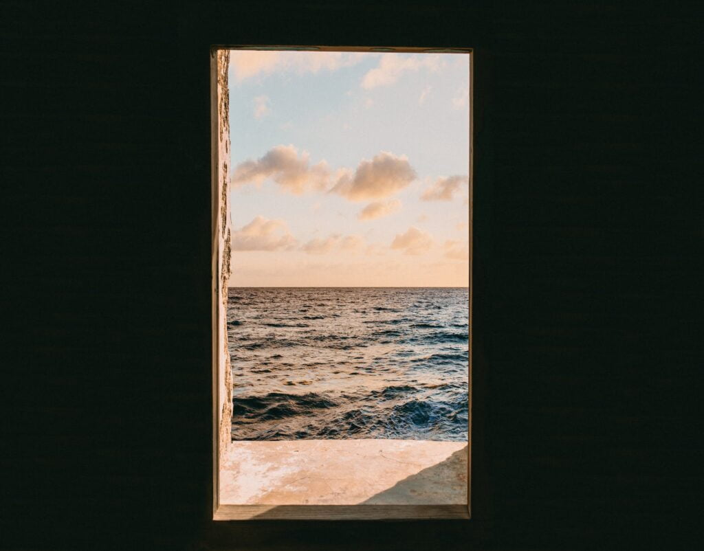 window view of sea during golden hour