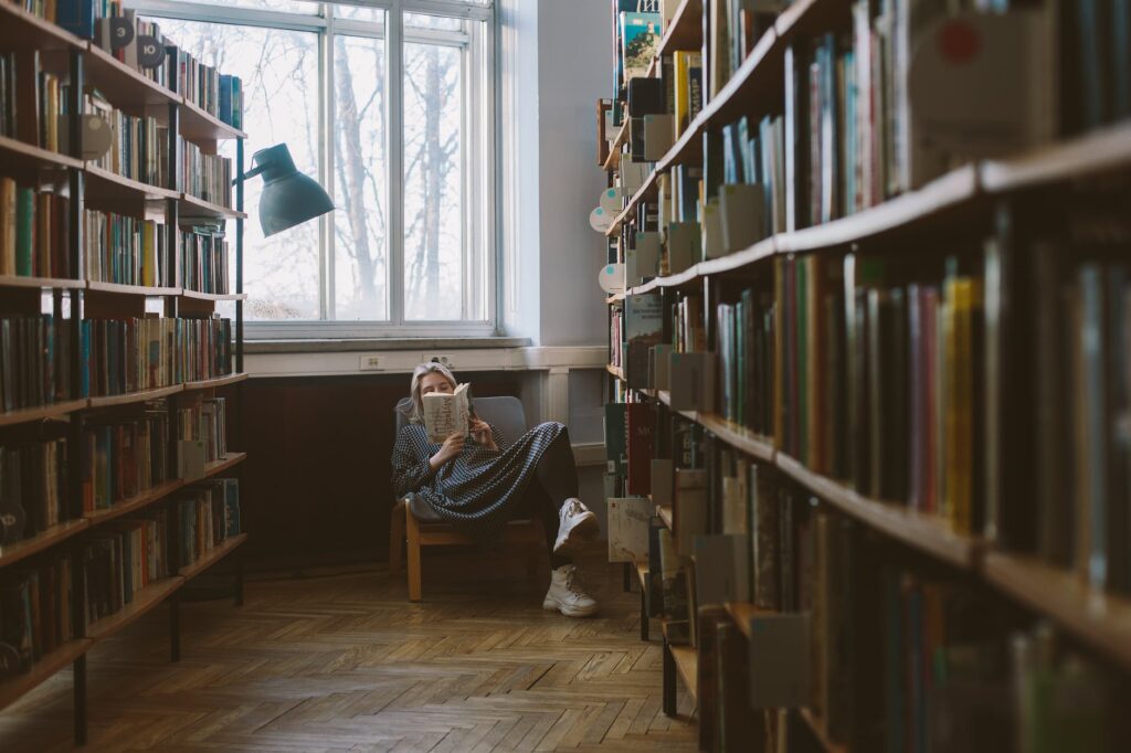 photo of woman reading book. Best books in July