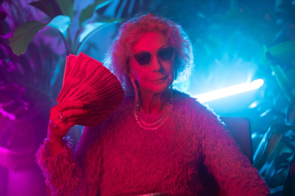 photo of an elderly woman flaunting money. Being effortlessly confident