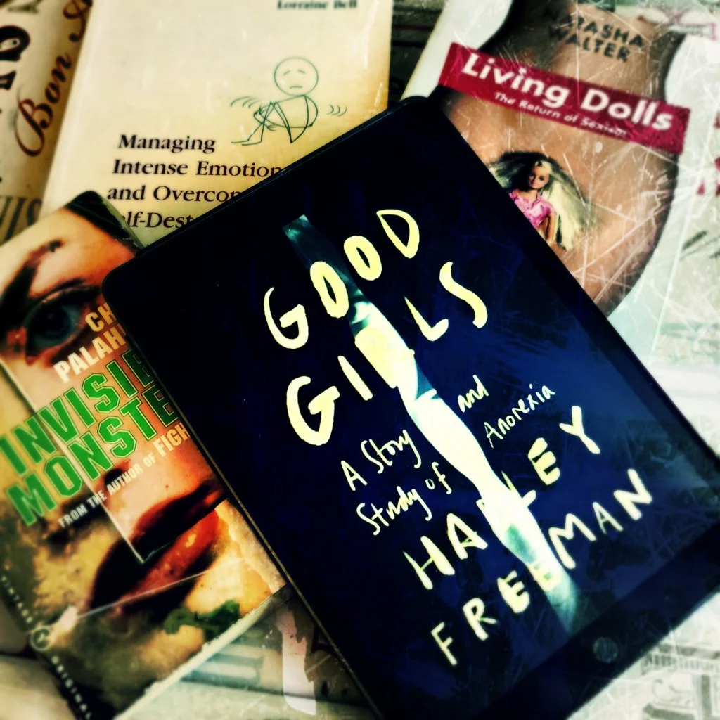 Hadley Freeman's Good Girls memoir surrounded by Natasha Walters' books Living Dolls with a Barbie on front cover, Chuck Palahniuk's Invisible Monsters book and Managing Intense Emotions and Overcoming Self-destructive Habits by Lorraine Bell