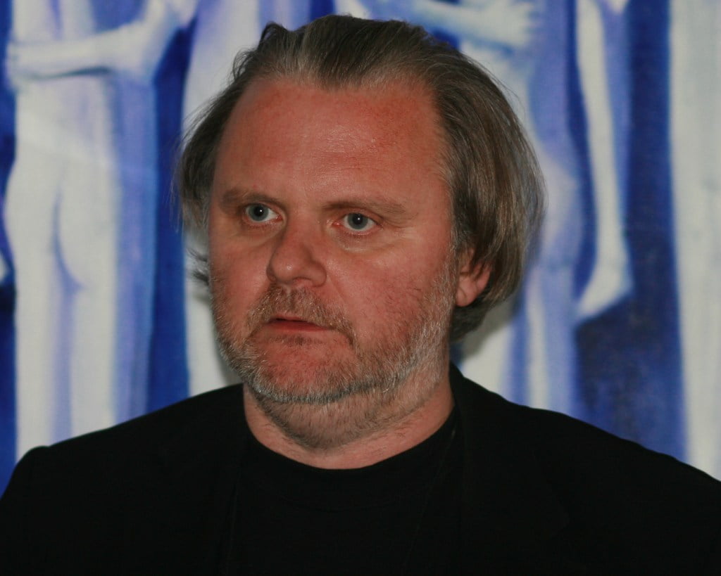 Jon Fosse in black top and black blazer in front of blue background as he as was announced as 2023 Nobel Prize for Literature winner.